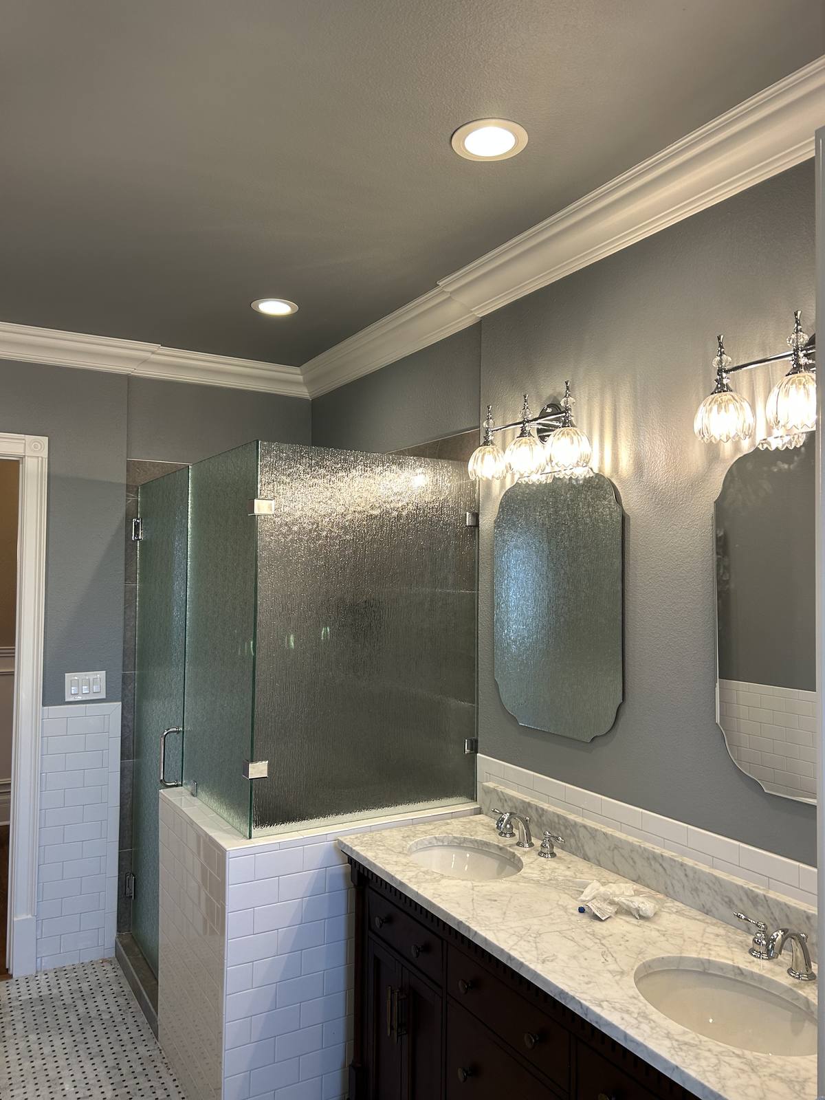 Renovated bathroom with double vanity by RCS Remodeling
