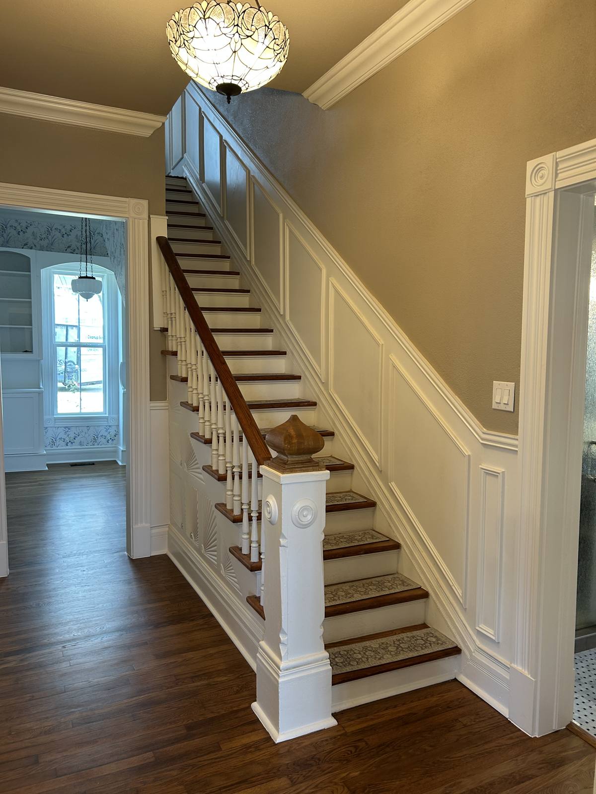 Staircase with custom wainscoting by RCS Remodeling